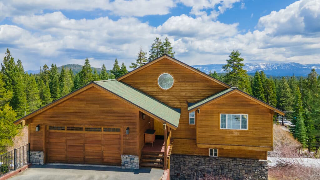 An aerial view of a vacation home, mountains visible in background