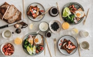 Easter egg hunt. Two children hunt for Easter eggs in a spring garden. Easter tradition. Laughing children in garden with basket spring