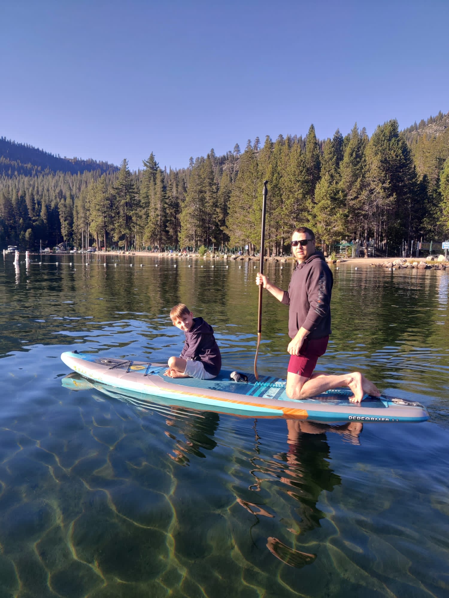 family enjoying paddleboarding on an SUP on Donner Lake