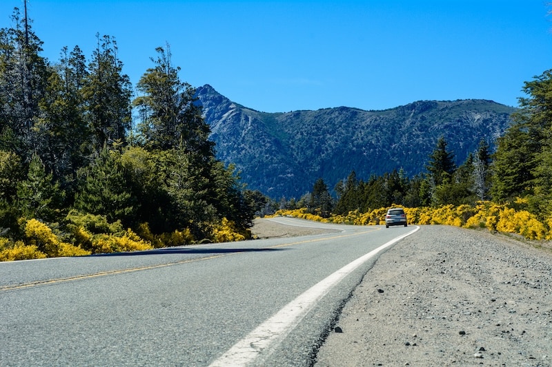 view-of-a-mountain-road-and-a-car-at-sunny-day-