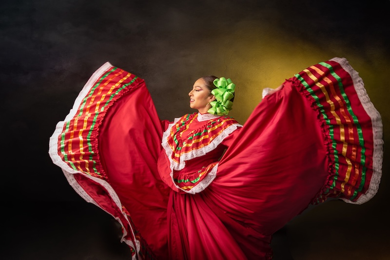 A woman in traditional Mexican dress dancing with her skirts