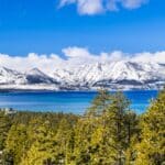 view of North Lake Tahoe with the snowy Sierra Mountains across the lake from a high viewpoint