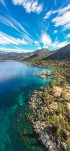 vertical image of a turquoise lake and stunning sky in North Lake Tahoe 