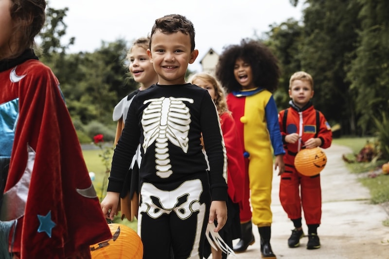 kids in halloween costumes heading out to trick or treat