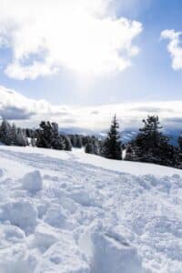 beautiful blue sky with fluffy clouds on a snowy mountain