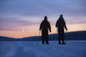 couple snowshoeing at sunset - Valentines Day snowshoeing