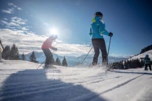 man and woman skiing and snowboarding in the mountains, ski resort