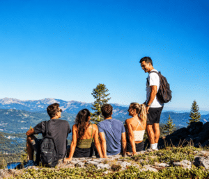 group of young friends at the summit of a hike in Northstar